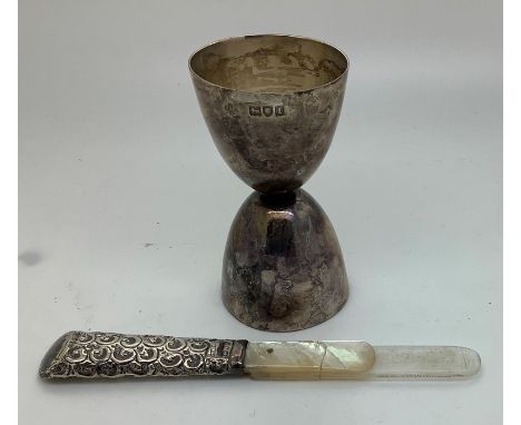 A silver spirit measuring cup, 39gms, London 1904 with a silver and mother of pearl bookmark a/f.