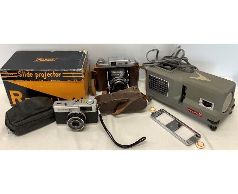 A Recall slide projector, an Olympus Trip 35 camera and a NKKI Westeh S-2 No. 46667 camera. 