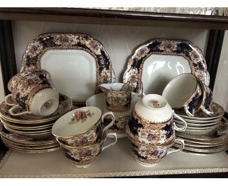 An 8 place tea service, milk, sugar and 2 bread plates. 