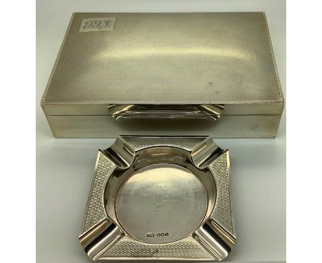A silver engine turned cigarette box, 17 x 11 x 4cms with an engine turned silver ashtray inscribed to centre for the opening