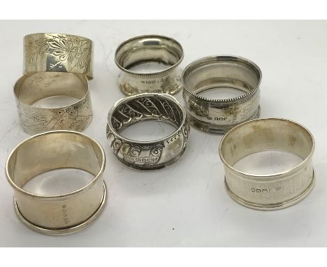 Seven silver napkin rings including 2 James Deakin + Sons, Sheffield 1882. 100.3gms. 
