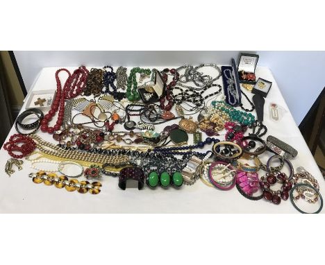 A large quantity of vintage costume jewellery including beads, bangles etc.