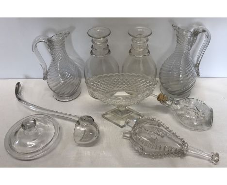 A collection of 19thC glass to include 2 jugs, two triple ring-necked decanters lacking stoppers, a boat shaped cut glass bow