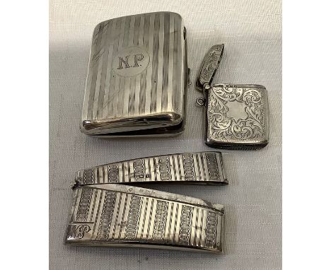 A silver card case with engine turned decoration, a cigarette card case and a vesta case with foliate engraving vacant cartou