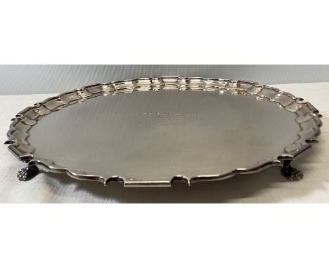 A good quality Georgian style silver salver with raised piecrust rim on lions paw feet. 31cms d. Birmingham 1964, 777.5gms. i