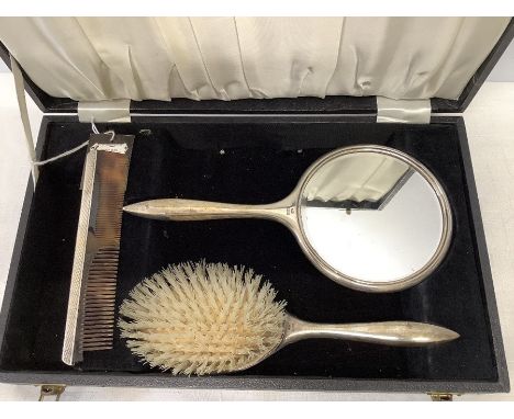 A boxed silver backed mirror, brush and comb, comb a/f, engine turned decoration, Birmingham 1973. Silver and mirror in good 