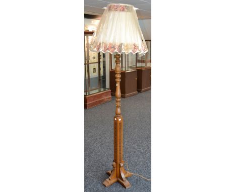 A carved and turned oak standard lamp 