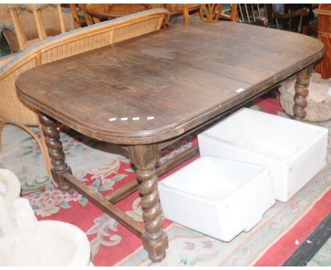 An oak D-end extending dining table, barley twist legs, ceramic casters