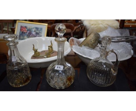 Three decanters; two wash bowls; a trivet; an Indian brass potpourri supported by stylized elephants; a brass watering can; a