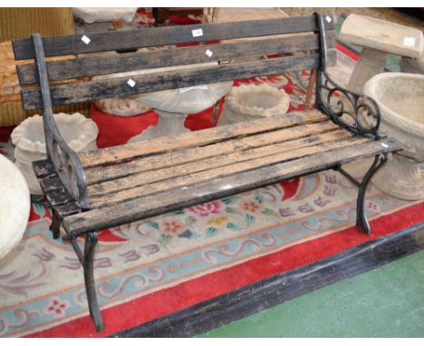 A garden bench ornate ends wooden slats 