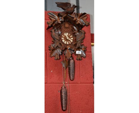 A black forest cuckoo clock, Roman numerals, weights and pendulum