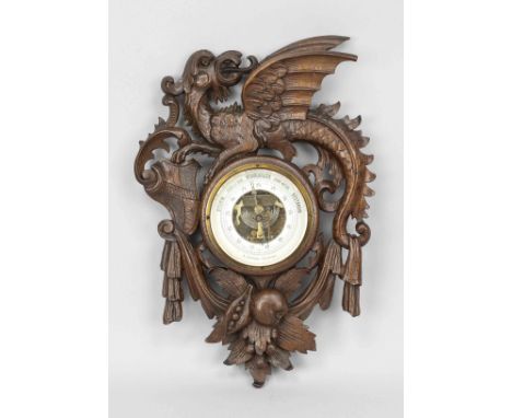 Barometer, Ende 19. Jh., dunkles Holz beschnitzt, durchbrochen gearbeitet. Rahmen mit Drache, Wappen und Früchten, leicht ber