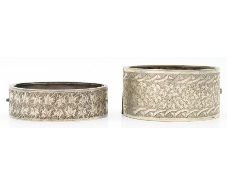 A Victorian silver hinged bangle, Chester 1882, and a silver fronted example 