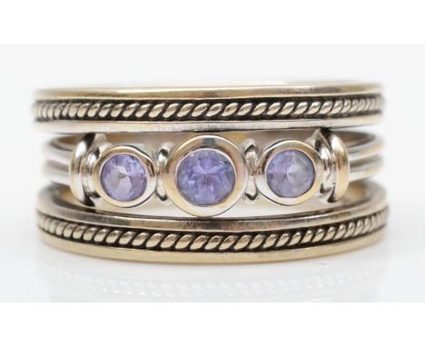 An 18ct white gold three stone tanzanite ring, flanked by two 9ct white gold rings, L, 6.5gm 