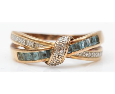 A 9ct gold topaz and diamond crossover ring, R, 3.2gm 