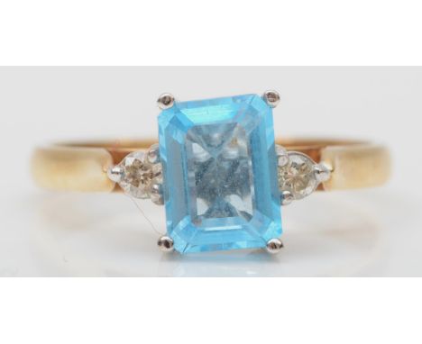 A 9ct gold blue stone and diamond three stone ring, P, 2.6gm 