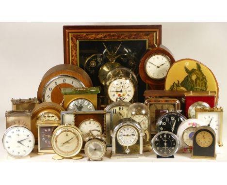 A collection of clock, including mechanical and quartz examples, including wall, alarm, anniversary, mantel, carriage and mor