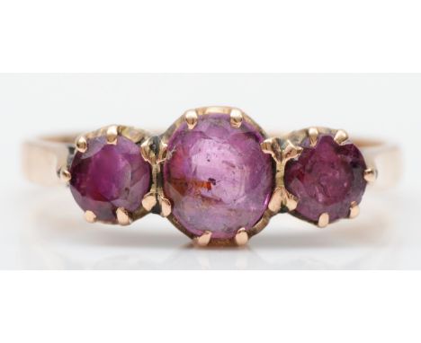 A 14K rose gold three stone ruby ring, N, 2.9gm 