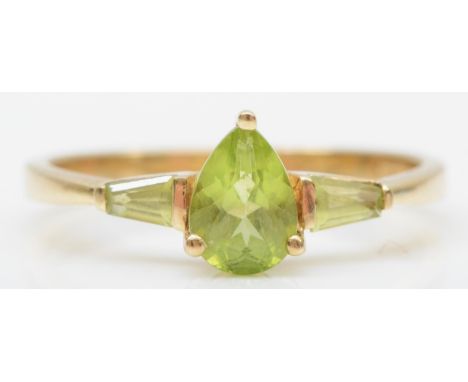 A 9ct gold and three stone peridot ring, P, 2gm 