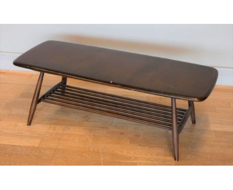 A 1960's Ercol occasional table, with slated under shelf on spayed legs, 106 x 35 x 45cm 