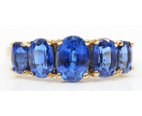 A 9ct gold five stone enhanced? sapphire ring, N, 2.4gm 