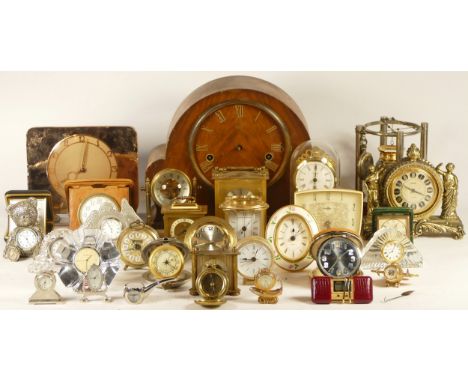 A collection of mechanical and quartz clocks, including a Art Deco desk clock, Smiths alarm clocks, 8 day travel clocks, anni