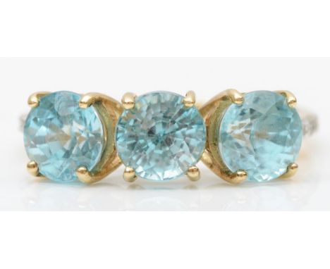 A 9ct gold three blue stone ring, white stone set shoulders, N, 3.1gm 