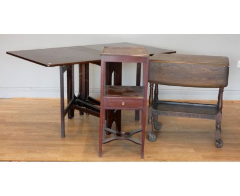 A mid 20th century mahogany drop leaf dining table, 83 x 144 x 74cm (extended), together with a mahogany night stand, one dra