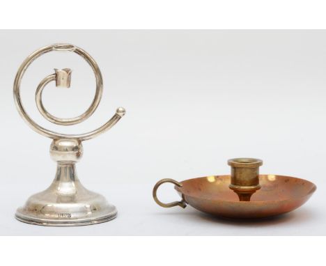 A silver coiled candlestick, London 1909, 11cm, loaded, together with a copper chamberstick 