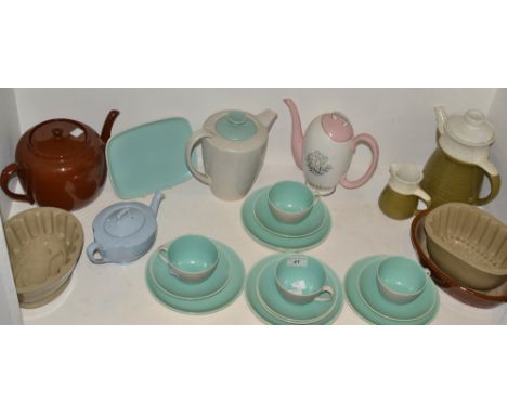 A brown saltglazed jelly mould;  another;  a part Poole tea service;  brown glazed teapot;  etc 