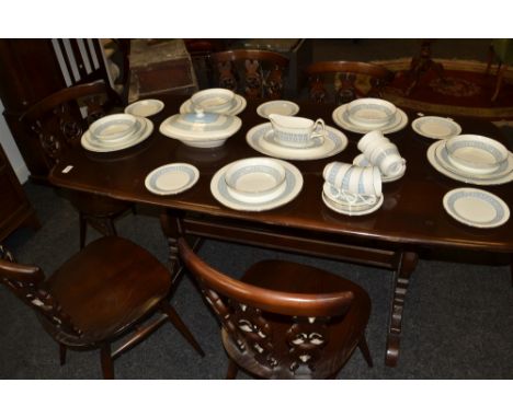 An Ercol dark wood dining table, a set of six dining chairs