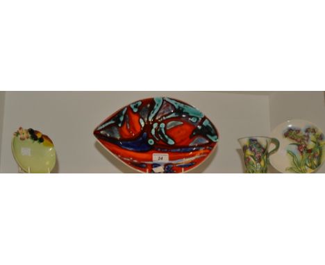 A Poole Delphis navette shaped dish, in tones of red and blue, c.1970;   a Carlton Ware Preserve dish;  a Benaya tube lined c