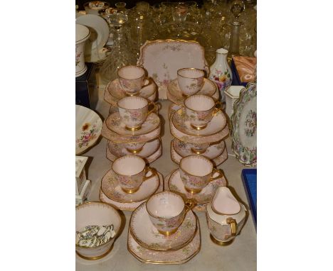 A Plant Tuscan Art Deco tea service for twelve, decorated with painted and gilt flowers, printed marks
