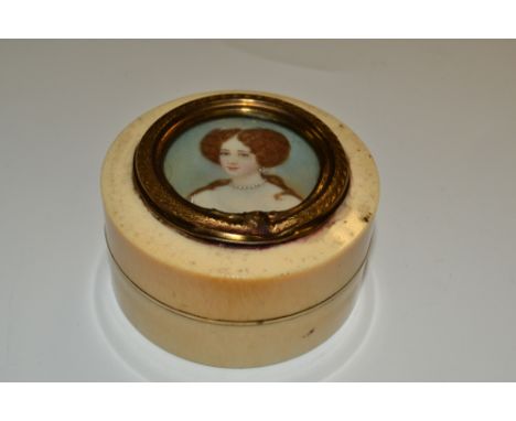 A 19th century ivory circular snuff box, the cover set with a watercolour portrait miniature