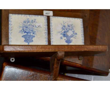 An oak wall shelf unit, blue and white tiled back