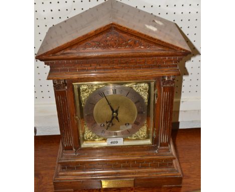 A late Victorian oak mantel clock, silvered chapter ring, pierced gilt cherub spandrels, twin winding holes, eight day moveme