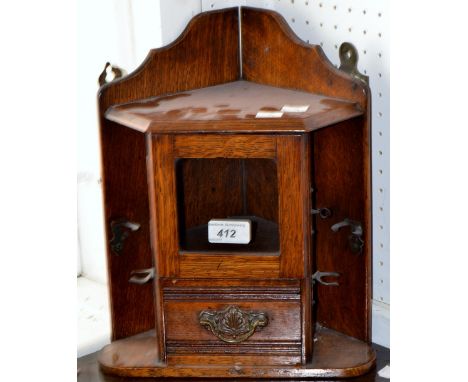 An oak wall hanging tobacco cabinet and pipe rack