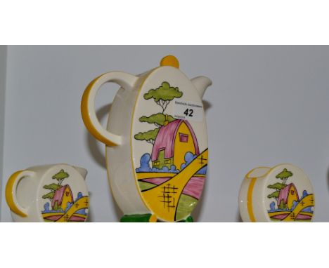 A Wedgewood Bizarre Clarice Cliff coffee pot, cream jug and sugar bowl