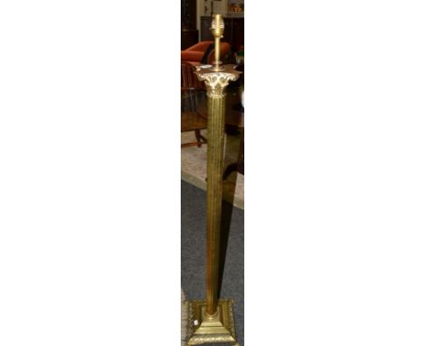 A brass effect Corinthian column standard lamp, stepped base;  a pine and leather seat (2)