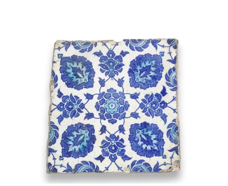 An Iznik pottery tile Turkey, 16th Centuryof irregular form, the white ground decorated in cobalt-blue and turquoise with a c