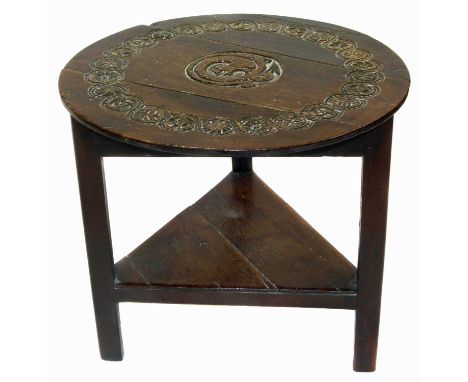 George III oak cricket table with later Victorian carving, three legs united by shelf, diameter 66cm (26").Condition report: 