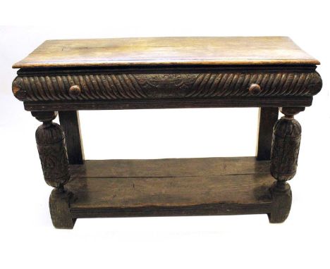 Late 18th-century continental side table, rectangular top with carved cushion frieze to three sides, large turned handles, cu