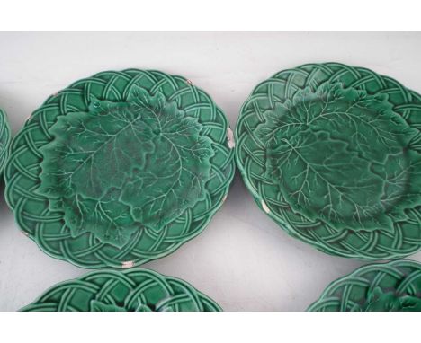 Nine Majolica plates, also a twin handled dish, moulded with leaves, late 19th century, 21cm diameterCONDITION REPORT: Overal