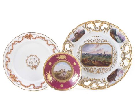 Continental wall plaque, plate and saucers, painted with topographical scenes, the plate with a monogram within ribbon border