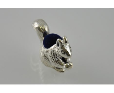 A silver squirrel shaped pin cushion 