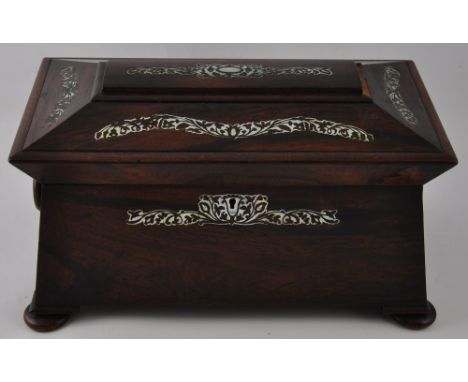 A Victorian mother of pearl inlaid rosewood sarcophagus tea caddy with lidded twin cannister interior on flat bun feet, w:36c
