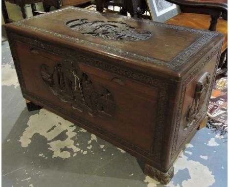 A Chinese carved camphor wood trunk decorated with garden scenes and seascapes on carved block feet, w:102cm 