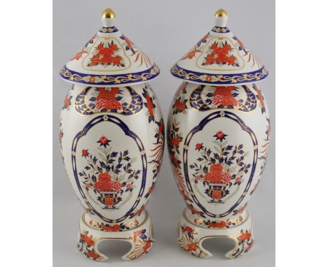 A pair of contemporary glazed ceramic lidded jars on bases, decorated in the Imari palette, H. 40cm (2)