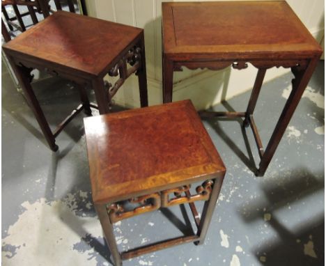 A nest of three Chinese hardwood tea tables with rectangular bur wood tops over pierced scroll friezes, on square underframes
