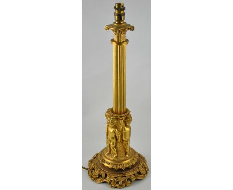 An early 20th Century ormolu table lamp with fluted column over a band of cast putti on pierced shell and scroll foot, H. 50c